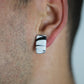 Model wears minimalist earrings in black and white marble print. He also wears handmade hair pins in the shape of a bow.